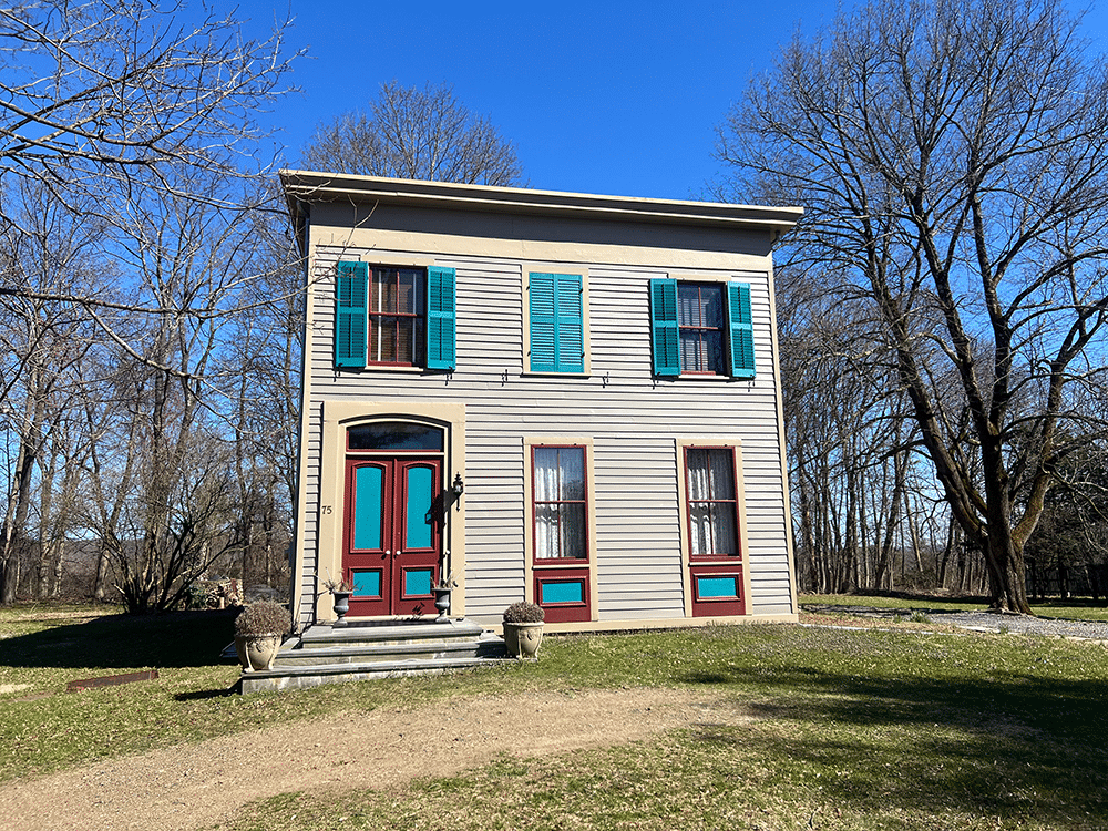 germantown - exterior of the wood frame italianate with teal shutters and oxblood trim