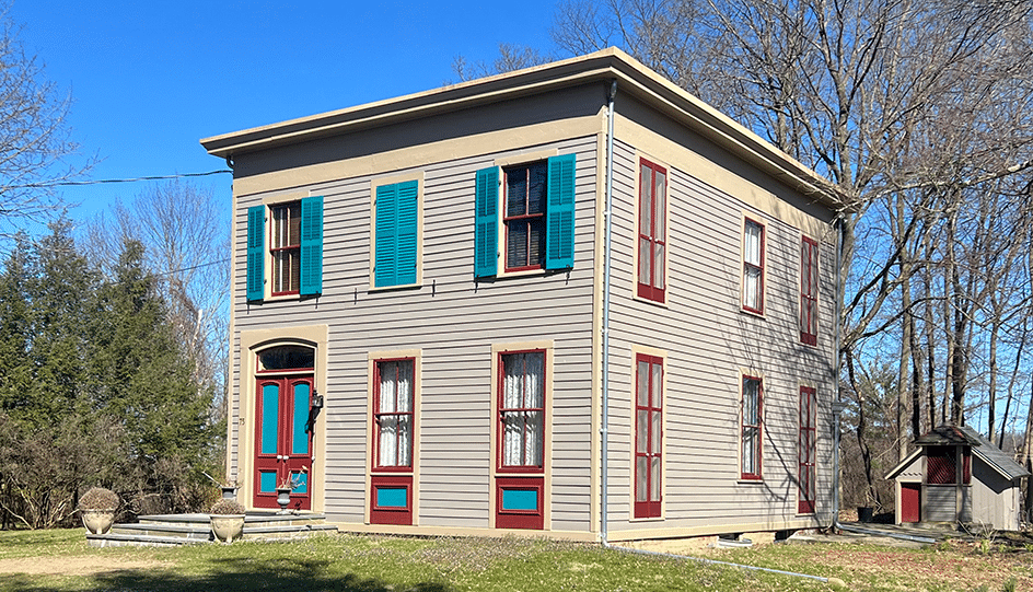 germantown - exterior of the wood frame italianate with teal shutters and oxblood trim