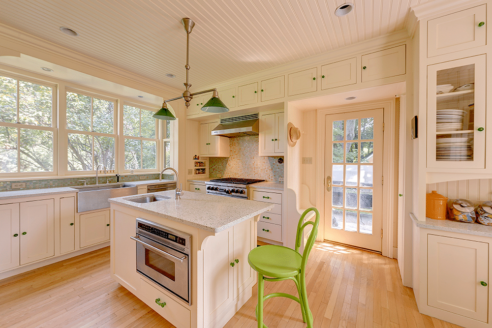 kitchen with straw yellow cabinets, a center island and a door to the garden