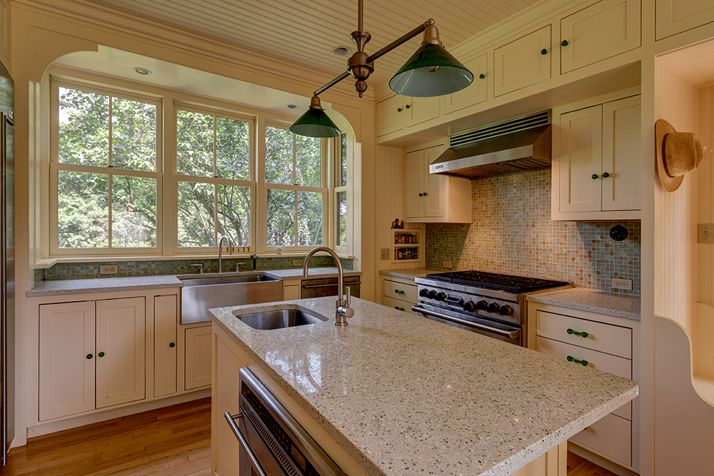 kitchen with straw yellow cabinets, a center island