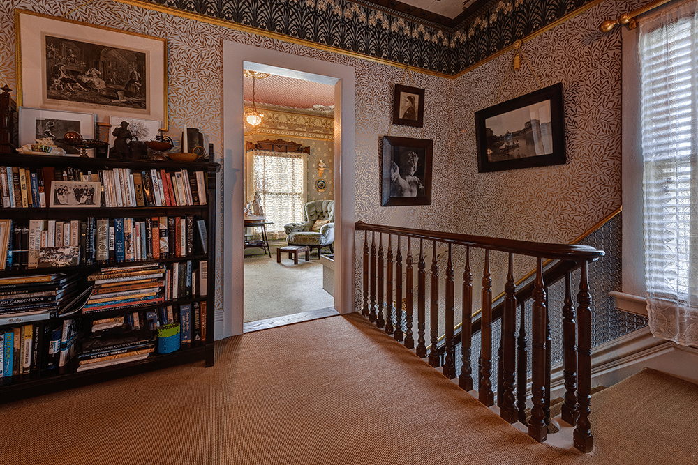 upstairs hall with original stair and wall and border papers