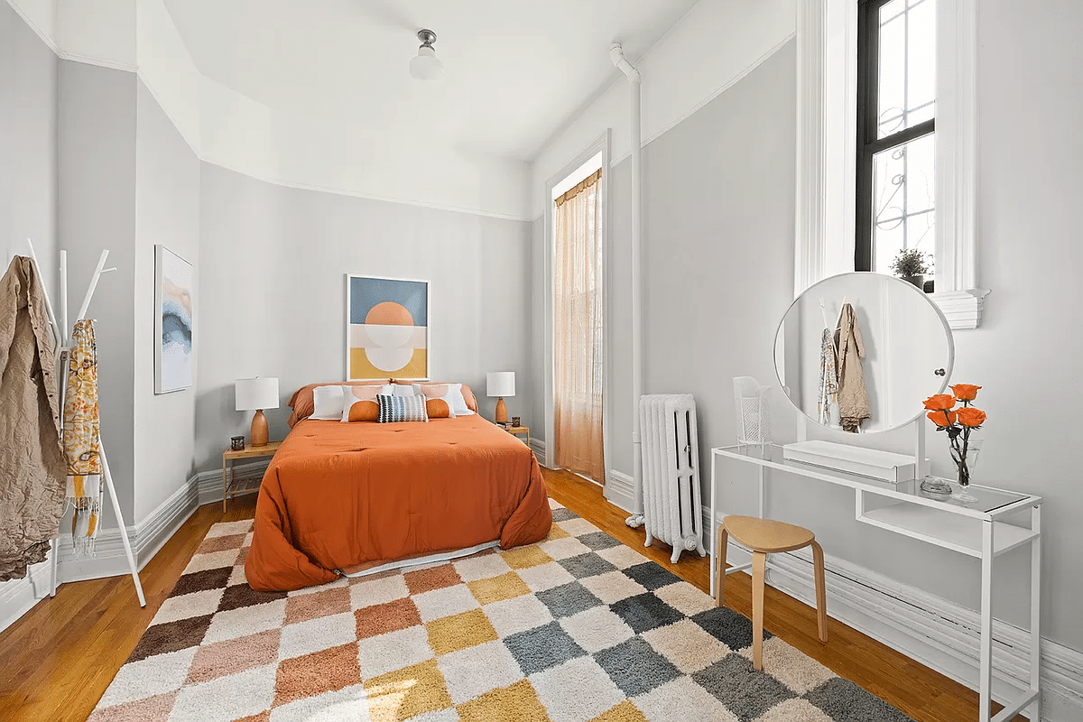 bedroom with picture rails, wood floor and three windows