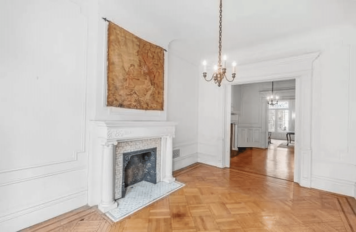 middle parlor with wall moldings and columned mantel