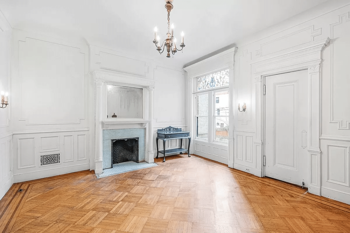 dining room with wall moldings, columned mantel and stained glass