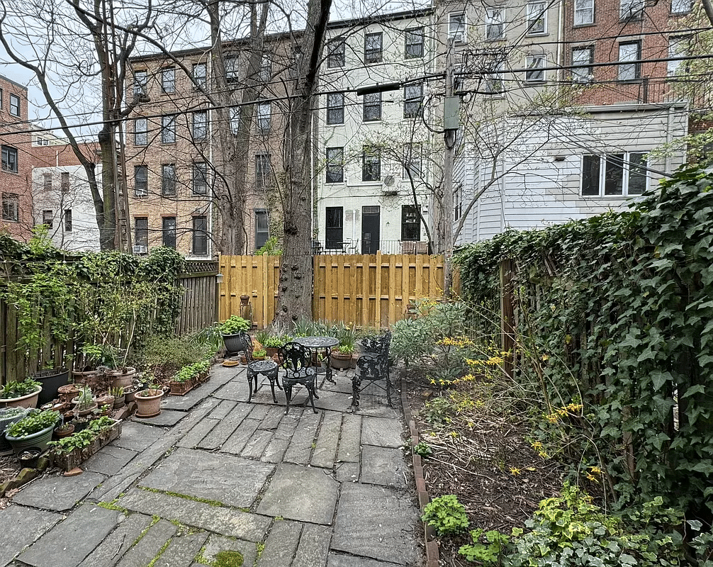 rear yard with stone paving and planting beds