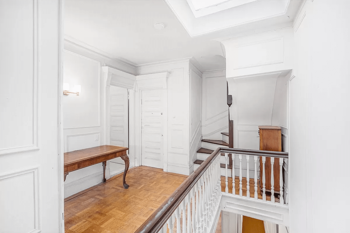 upstairs hall with wall moldings and wood floor