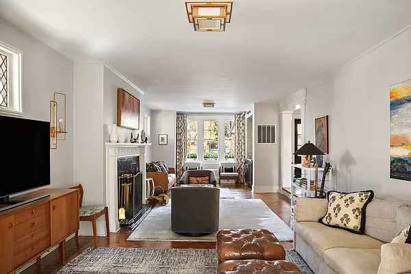 parlor with mantel and wood floors