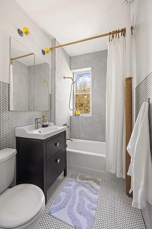 sunset park - bedroom with white penny tile with black grout on walls and floor