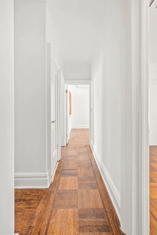sunset park - hallway with wood floors and white walls