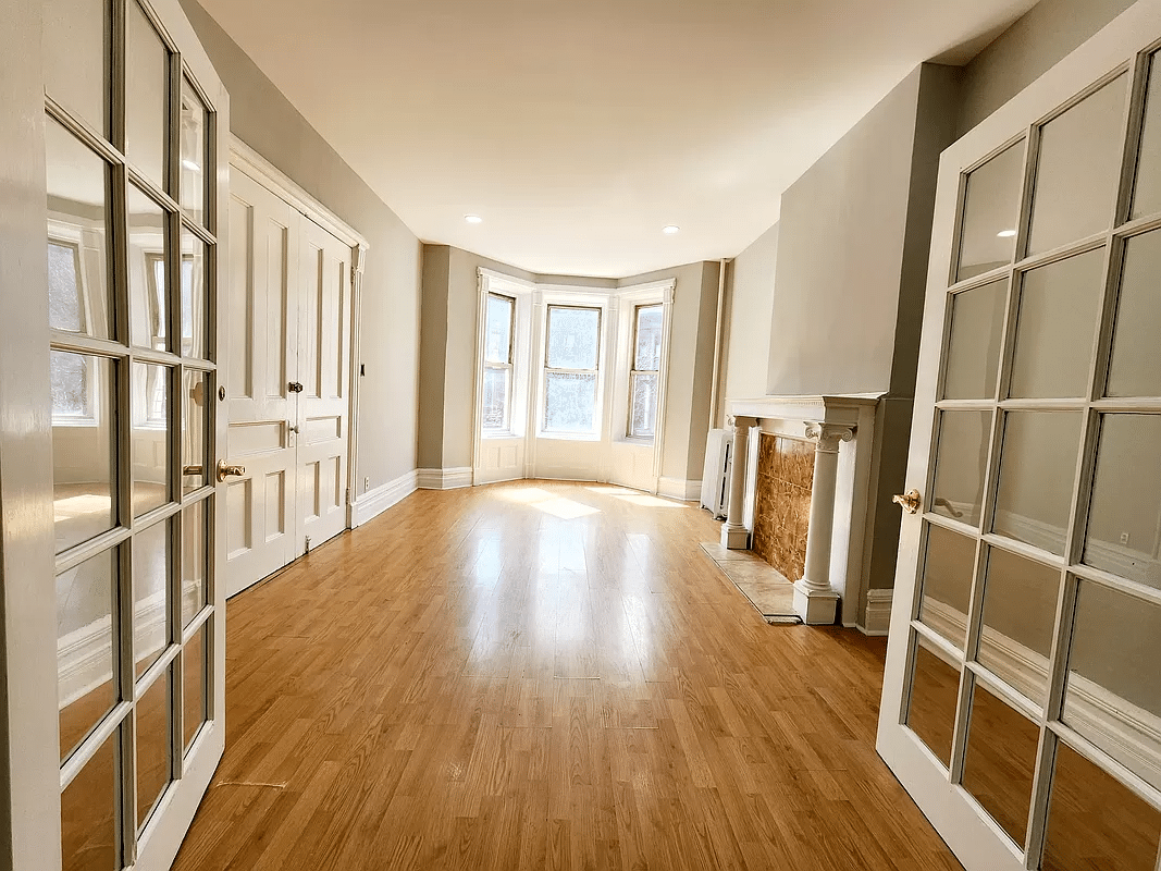 street facing room with french doors and a columned mantel
