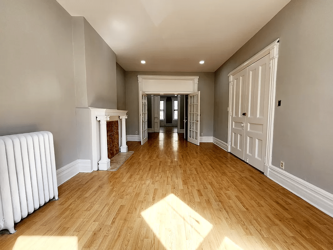 street facing room with french doors and a columned mantel