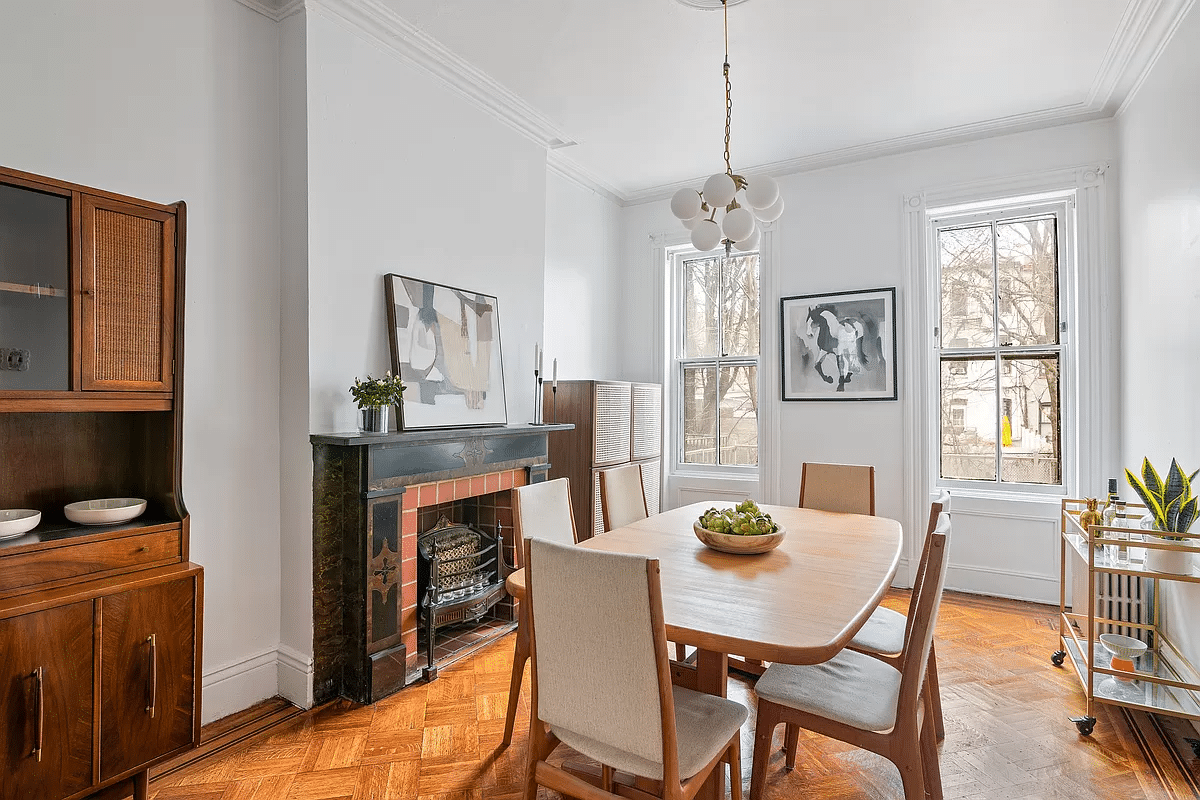 dining room with mantel and parquet floor