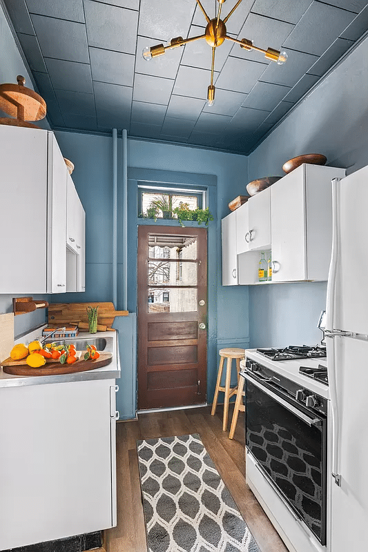 kitchen with blue walls and ceiling and white cabinets