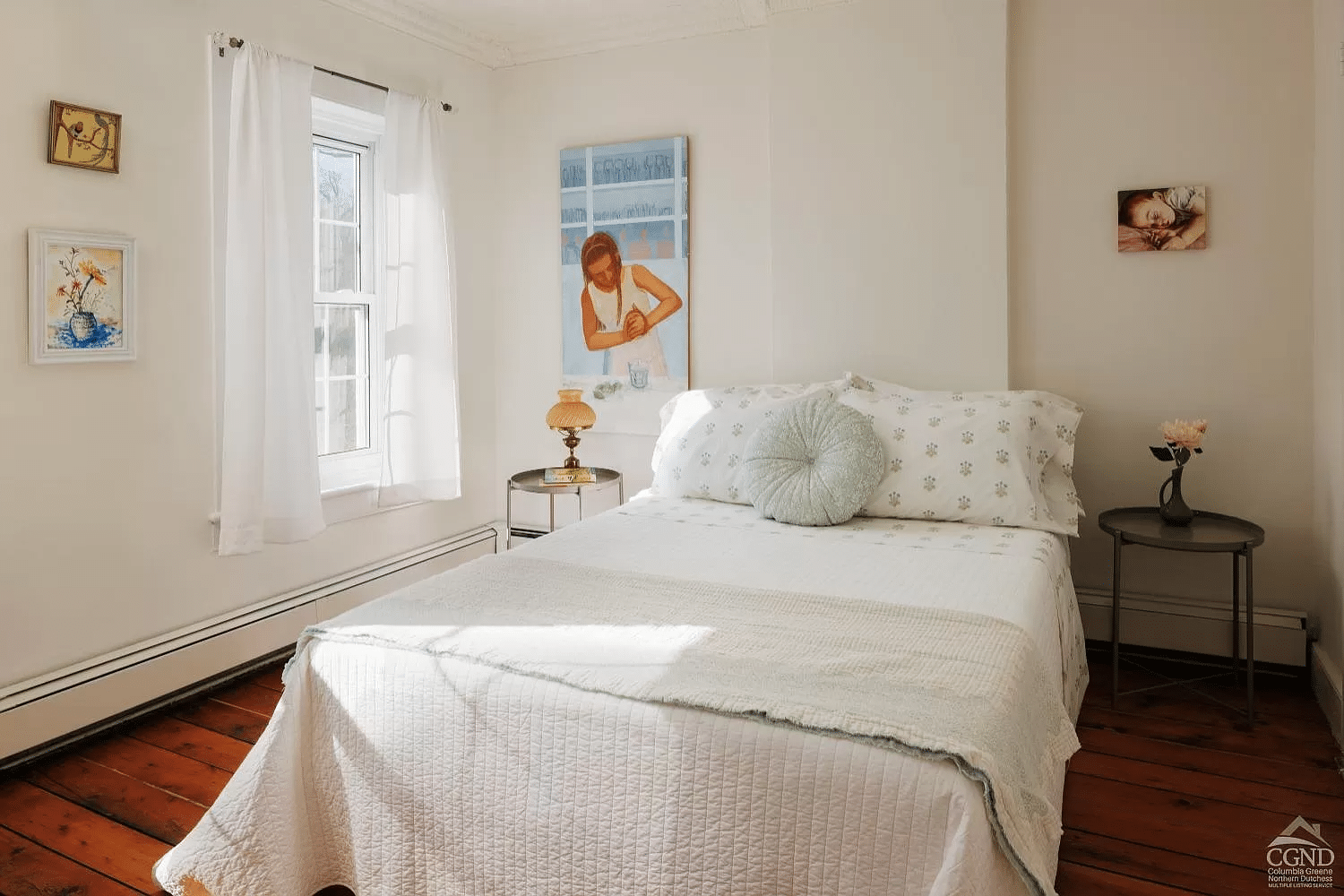 bedroom with wood floor, baseboard heating