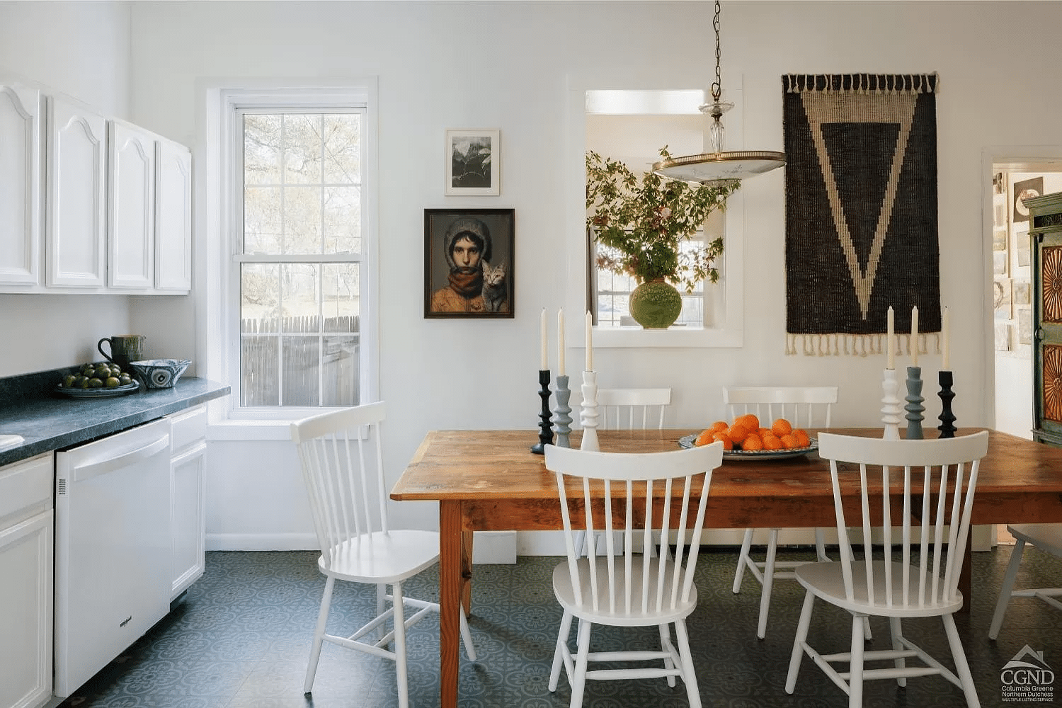 kitchen with white walls, tile floor and white cabinets