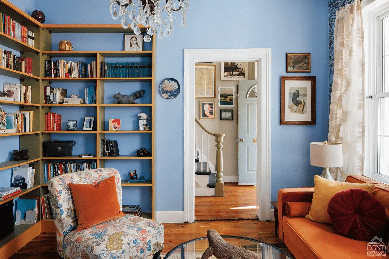 athens - living room with blue walls and view into entry