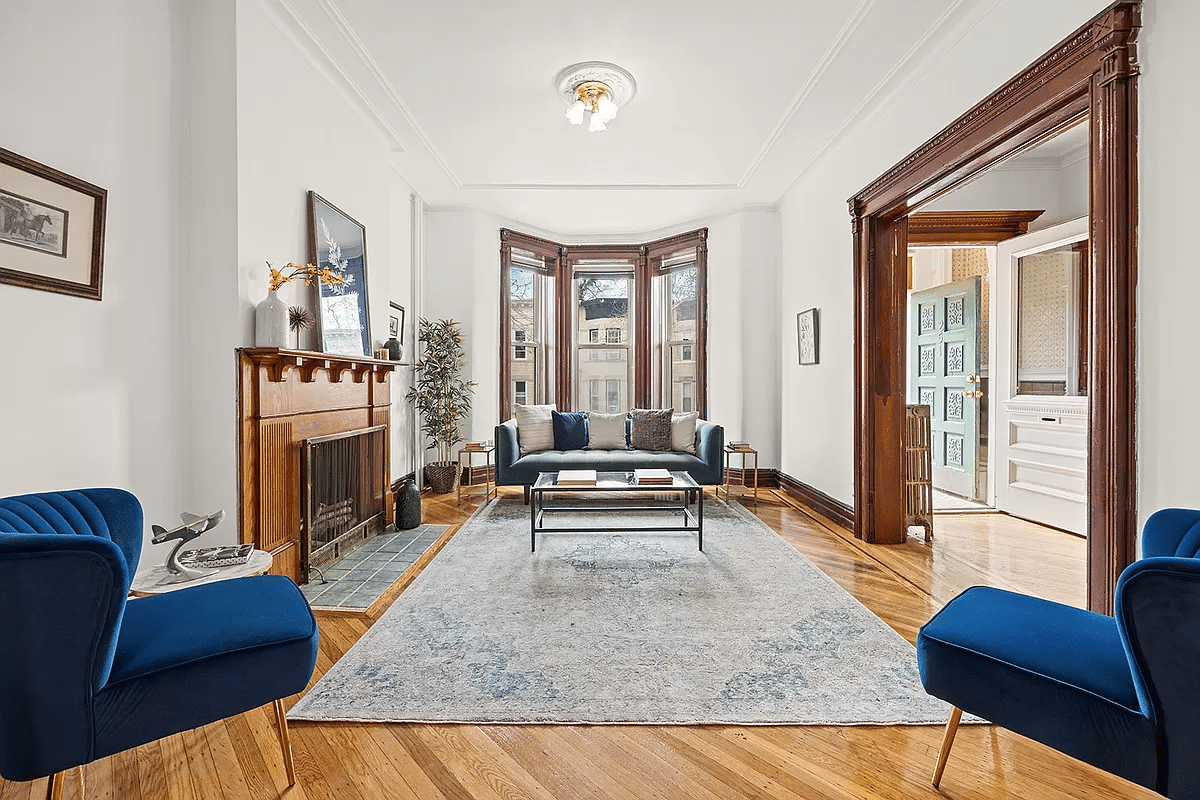 parlor with wood floor and mantel