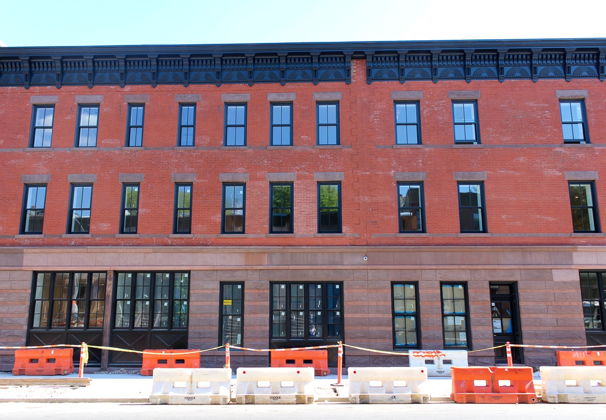 row of brick houses with brownstone bases