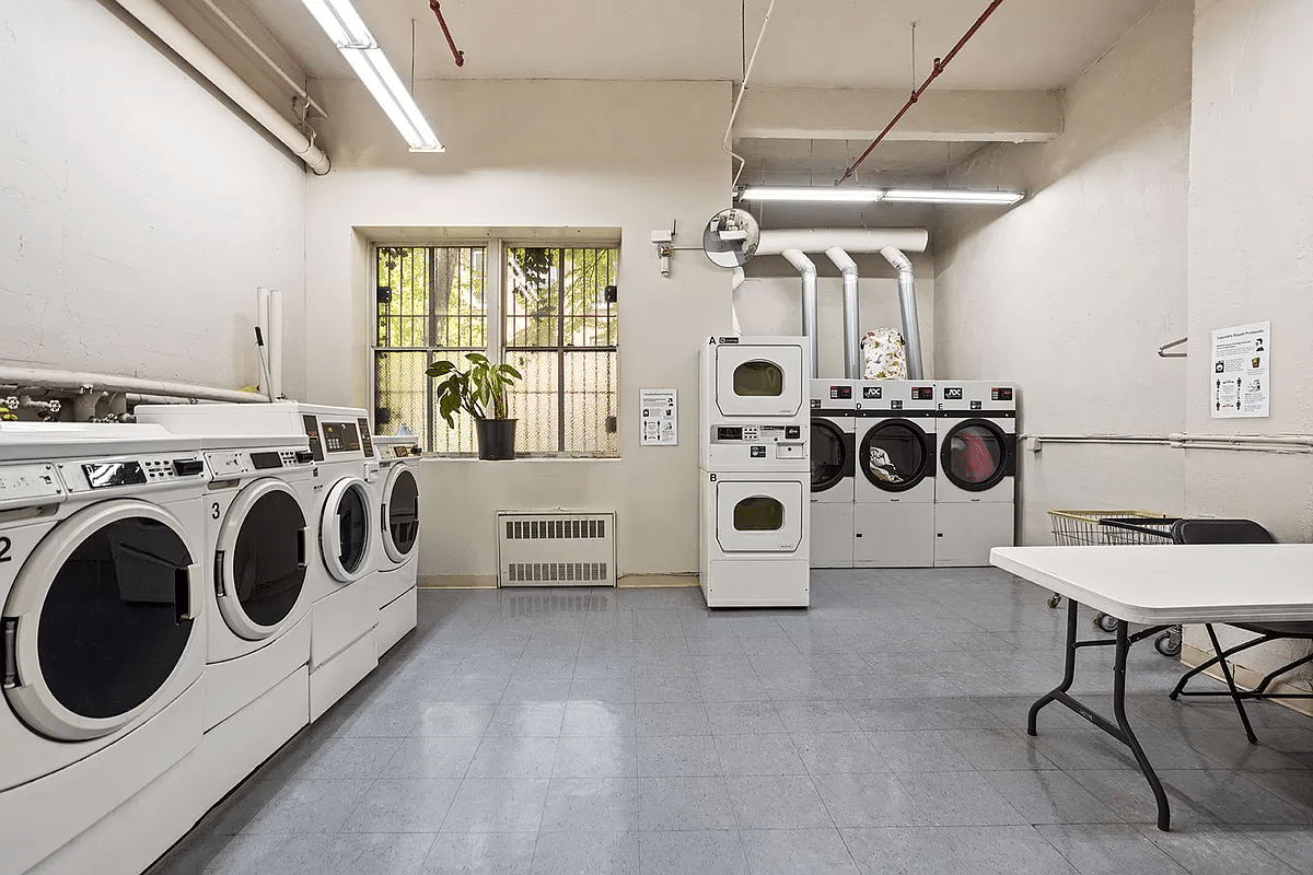 laundry room with multiple washers and dryers