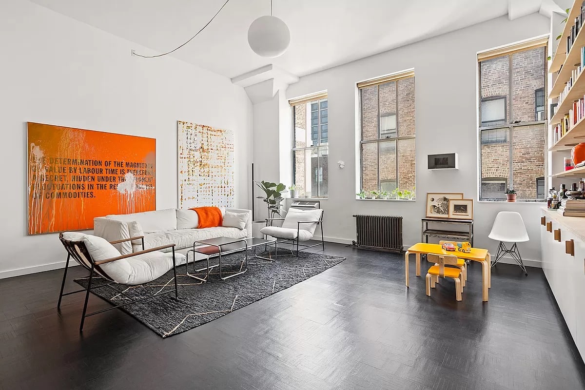 Boerum hill - living room with three windows, dark floor, bookshelves