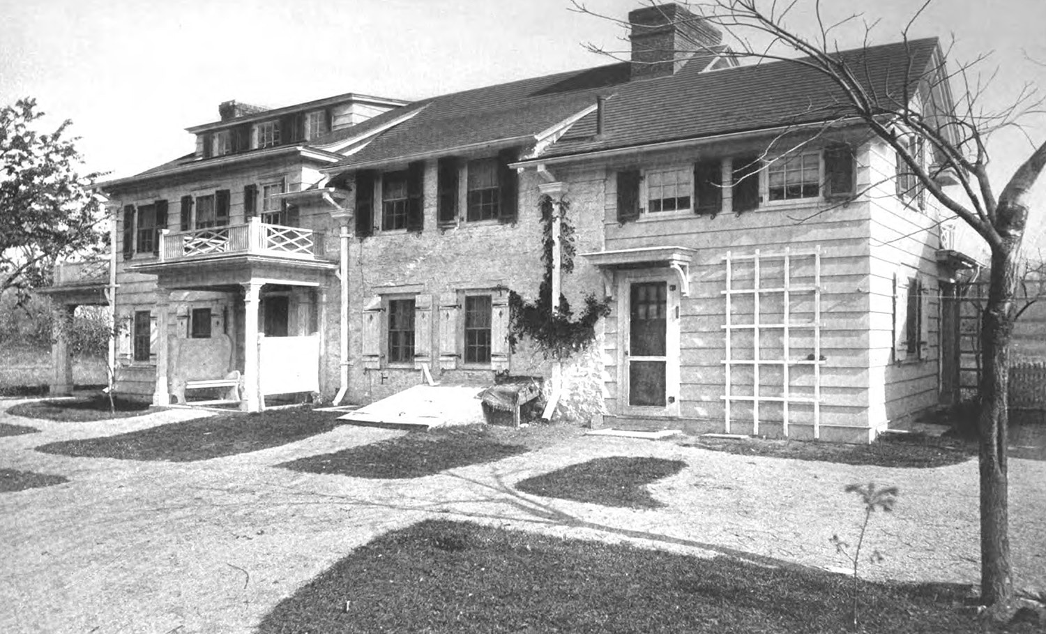 black and white image showing the stone house with wings on either side