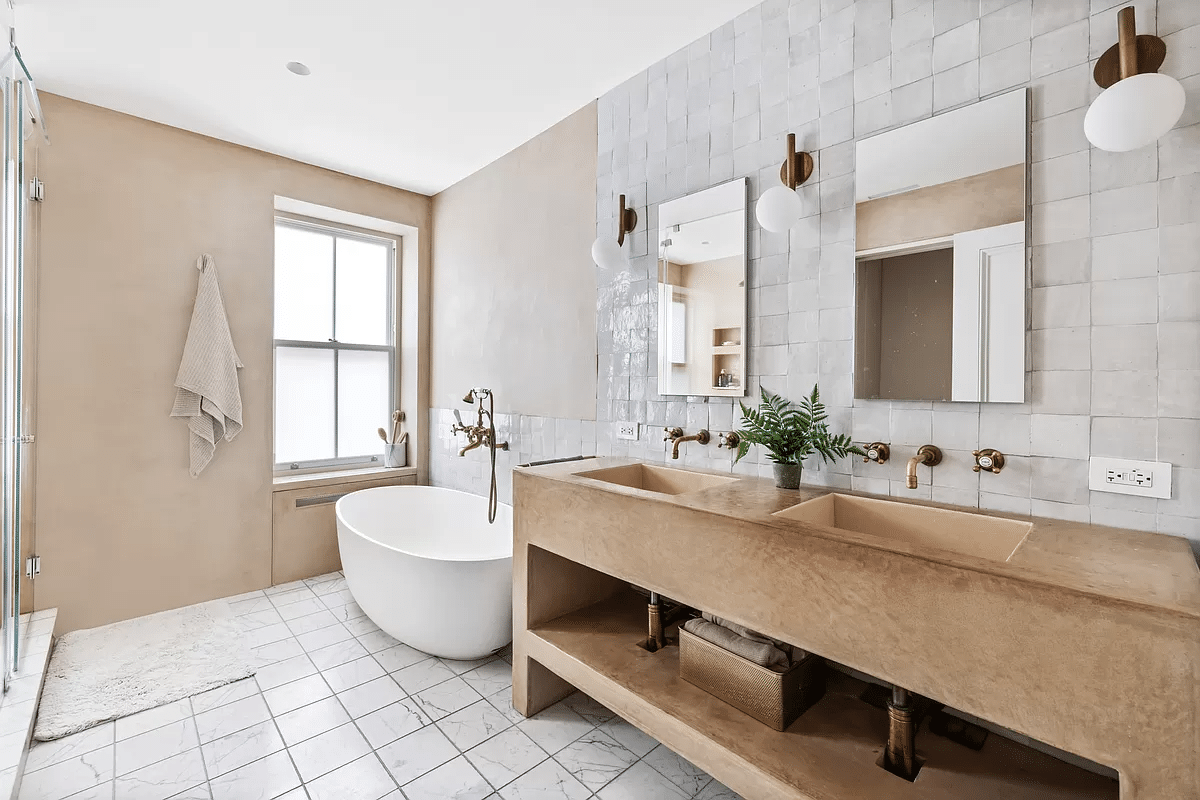 bathroom with a double vanity and a soaking tub