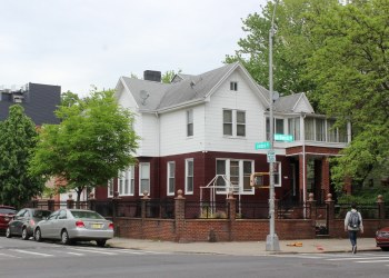 bushwick - standalone house surrounded by brick wall and fence