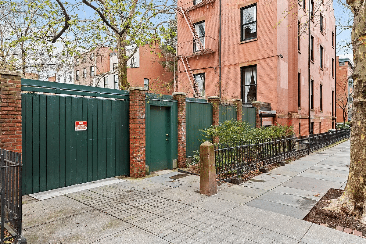 driveway with green gate to parking area