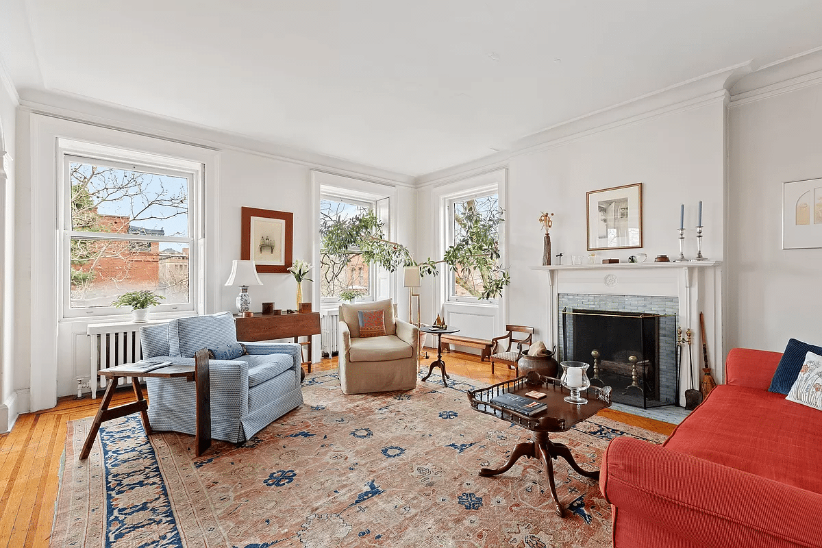 living room with multiple exposures and a mantel