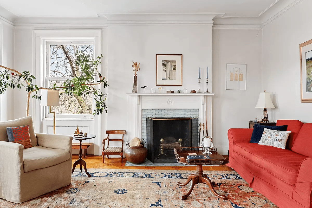 living room with white painted mantel with blue tile surround