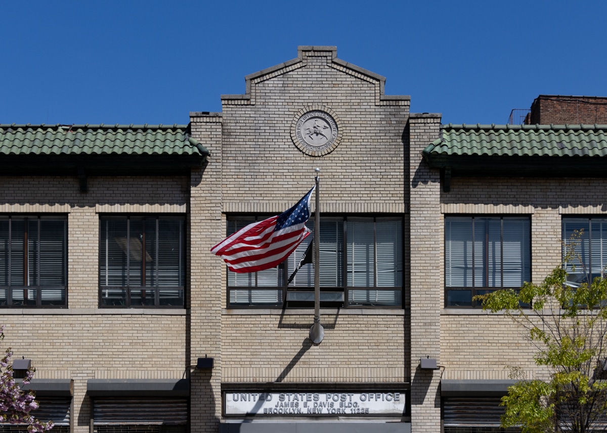 brooklyn - flag flying in front of a post office in crown heights