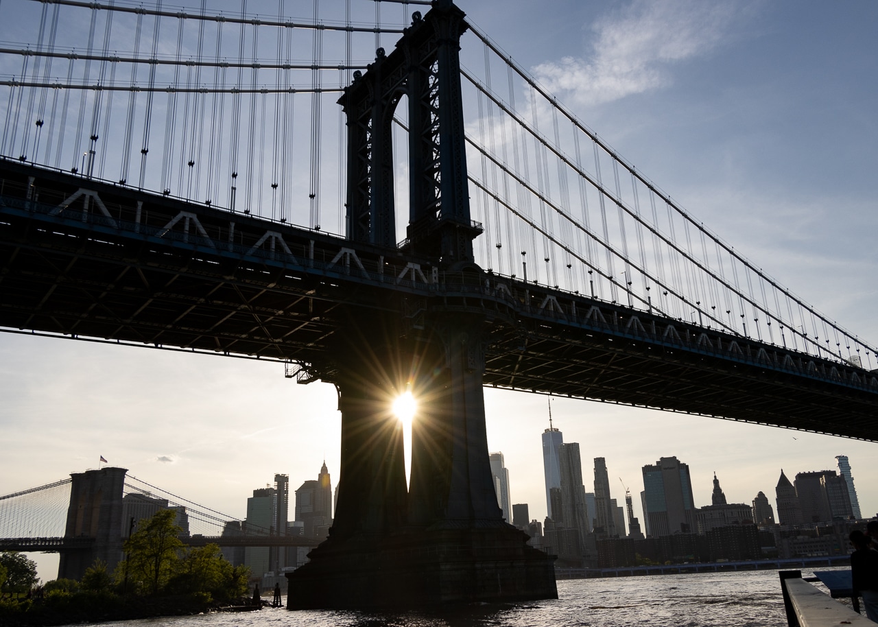 brooklyn - sun shining through the Manhattan Bridge near sunset