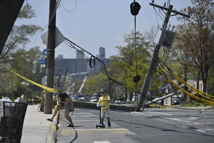 people ducking under police tape and power lines