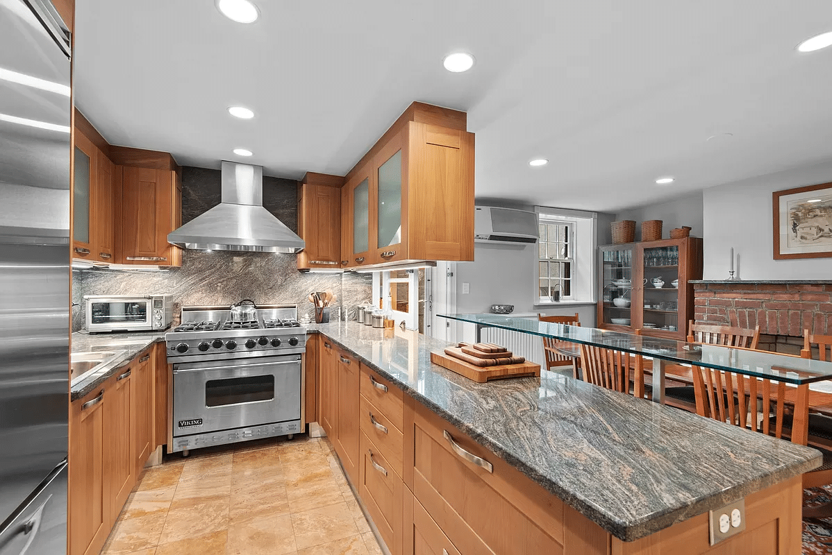 kitchen with wood cabinets, peninsula between dining area