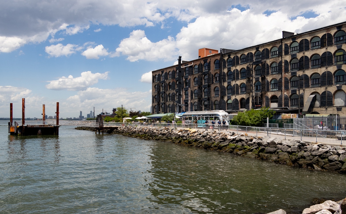 red hook - warehouse at the waterfront with manhattan skyline in the distance