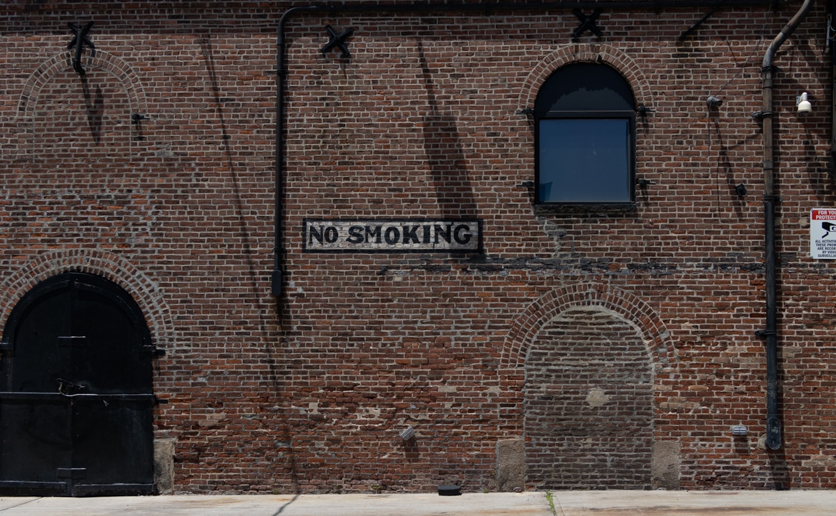red hook - warehouse with a no smoking sign painted on the brick exterior