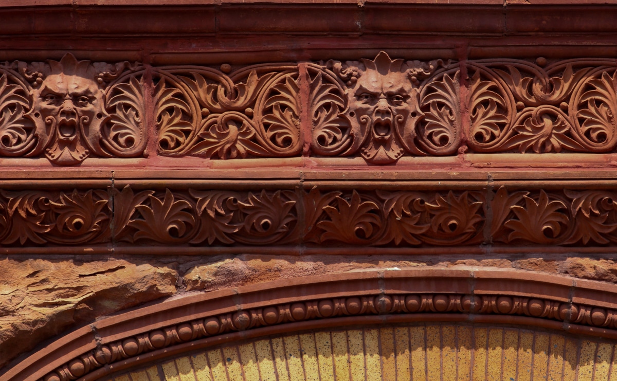 Brooklyn- terra cotta ornament,including faces, on a bed stuy building