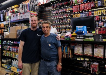 father and son posing near the register
