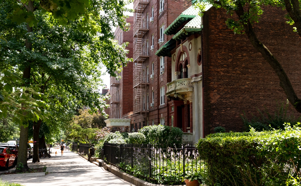 clinton hill -a house and apartment building on tree-shaded clinton avenue