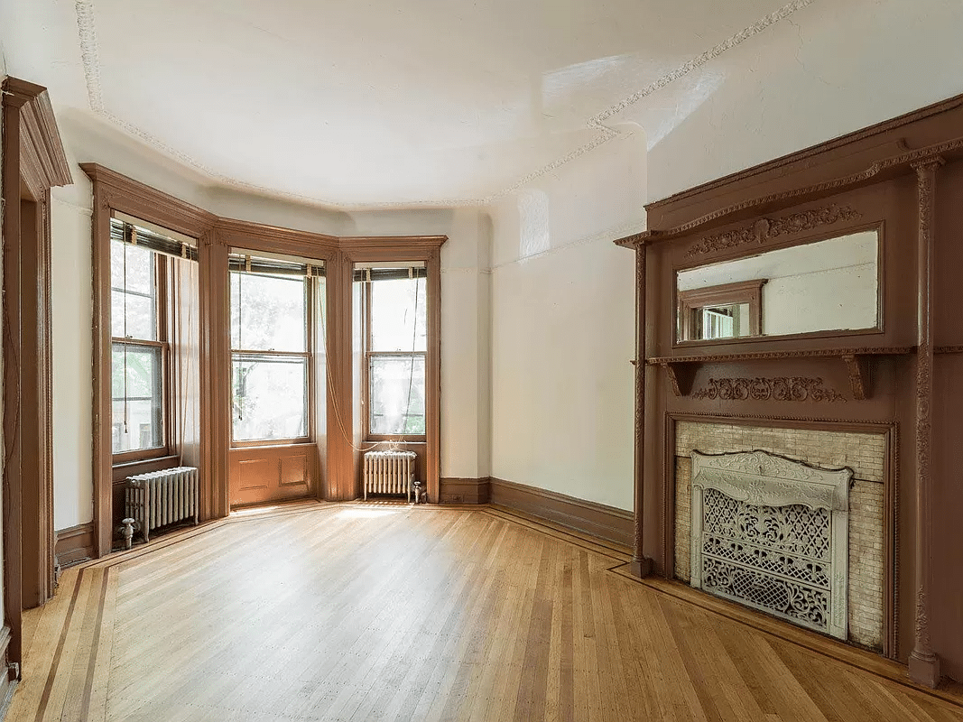 room with mantel, bay window