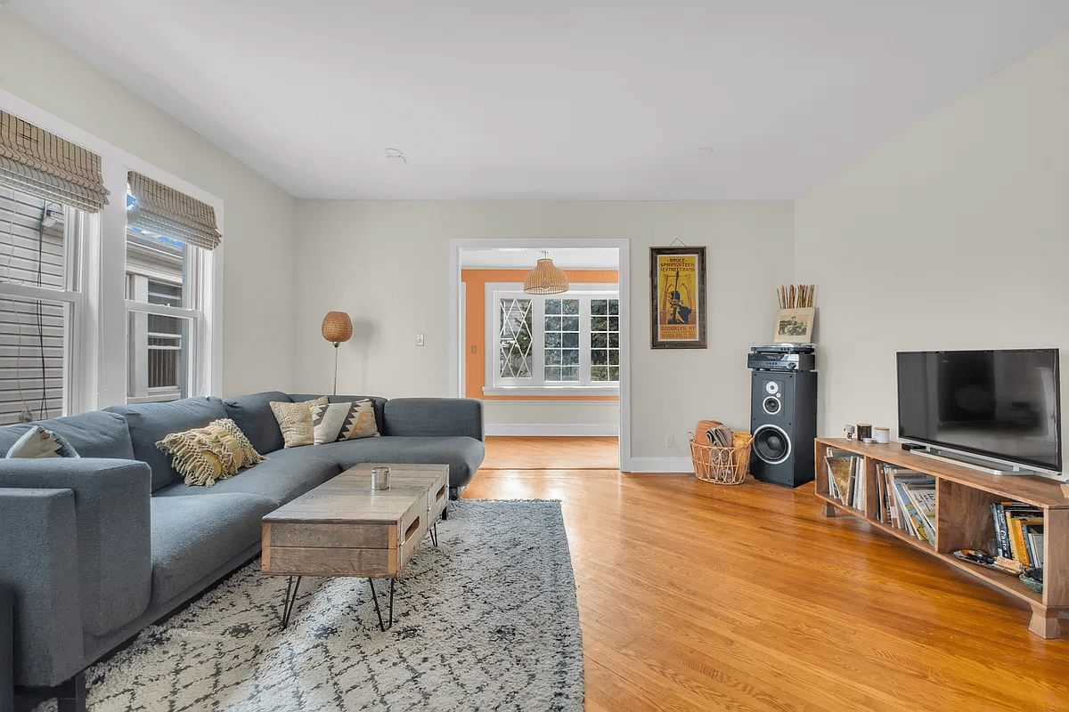 living room with wood floor, white walls