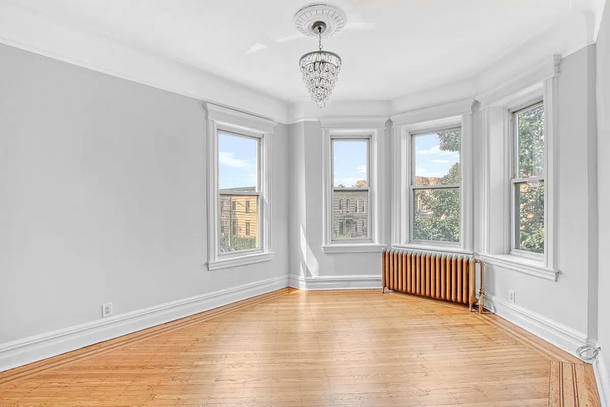 bedroom with wood floor, two exposures