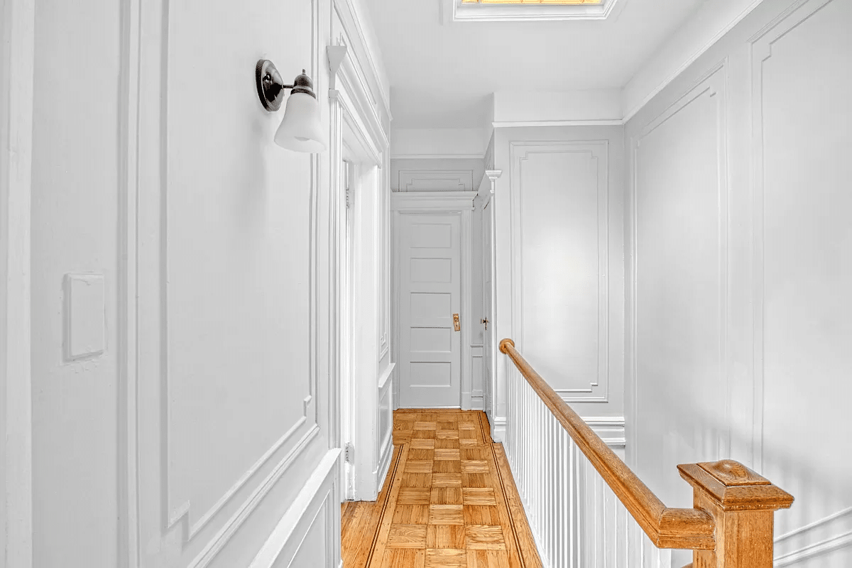 stair hall with wood floor, wall moldings