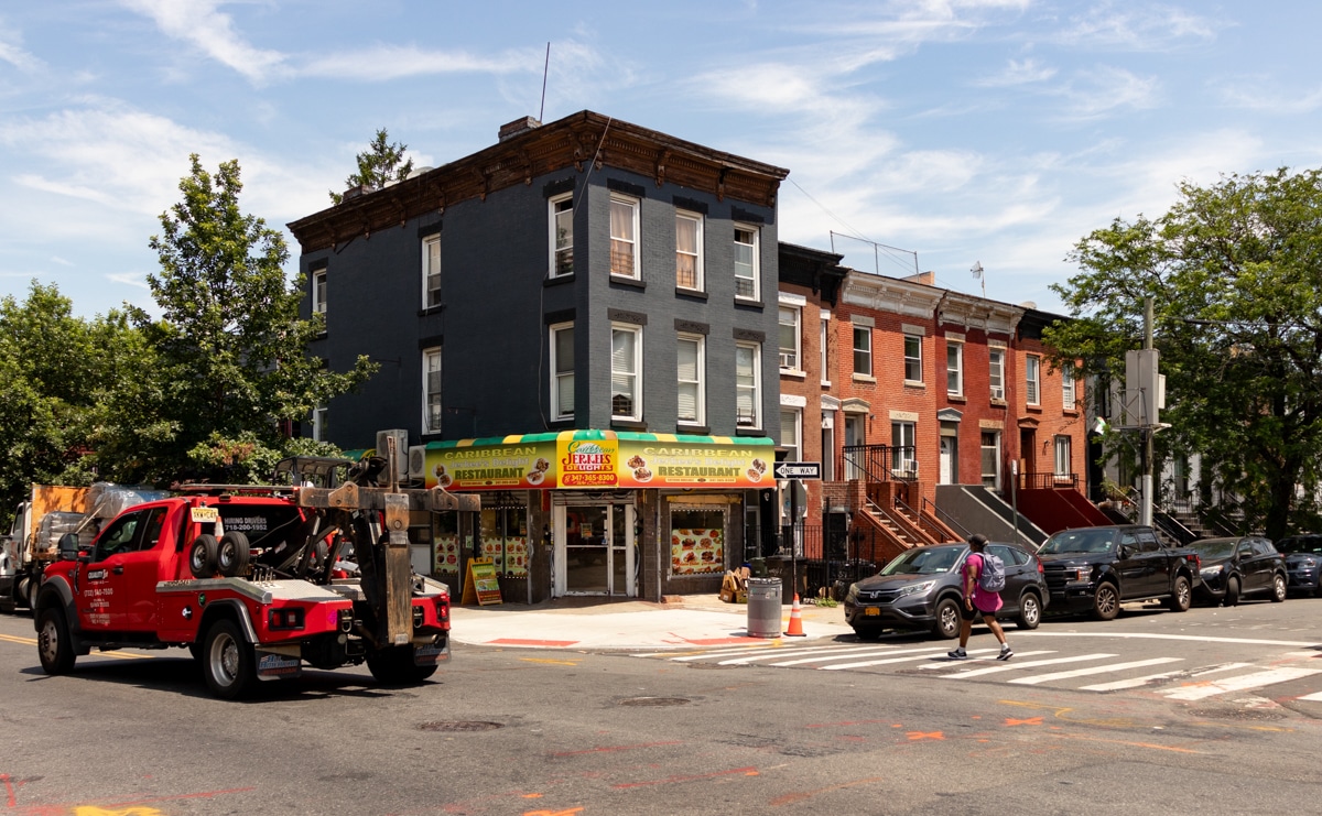 ocean hill - low scale brick buildings with a tow truck driving by