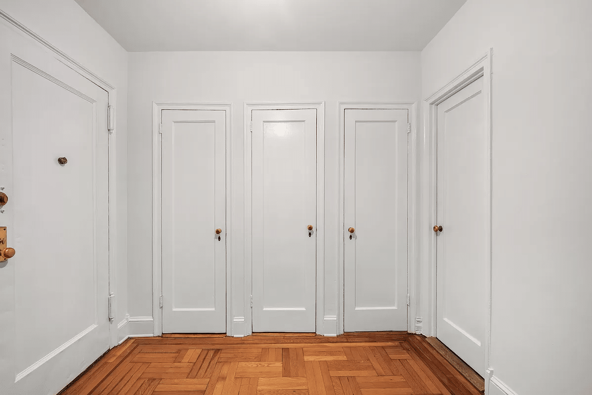 wall of closets in the foyer