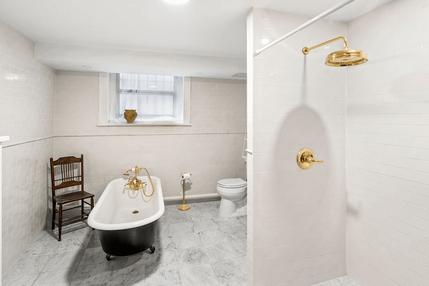 bathroom with claw foot tub and a shower