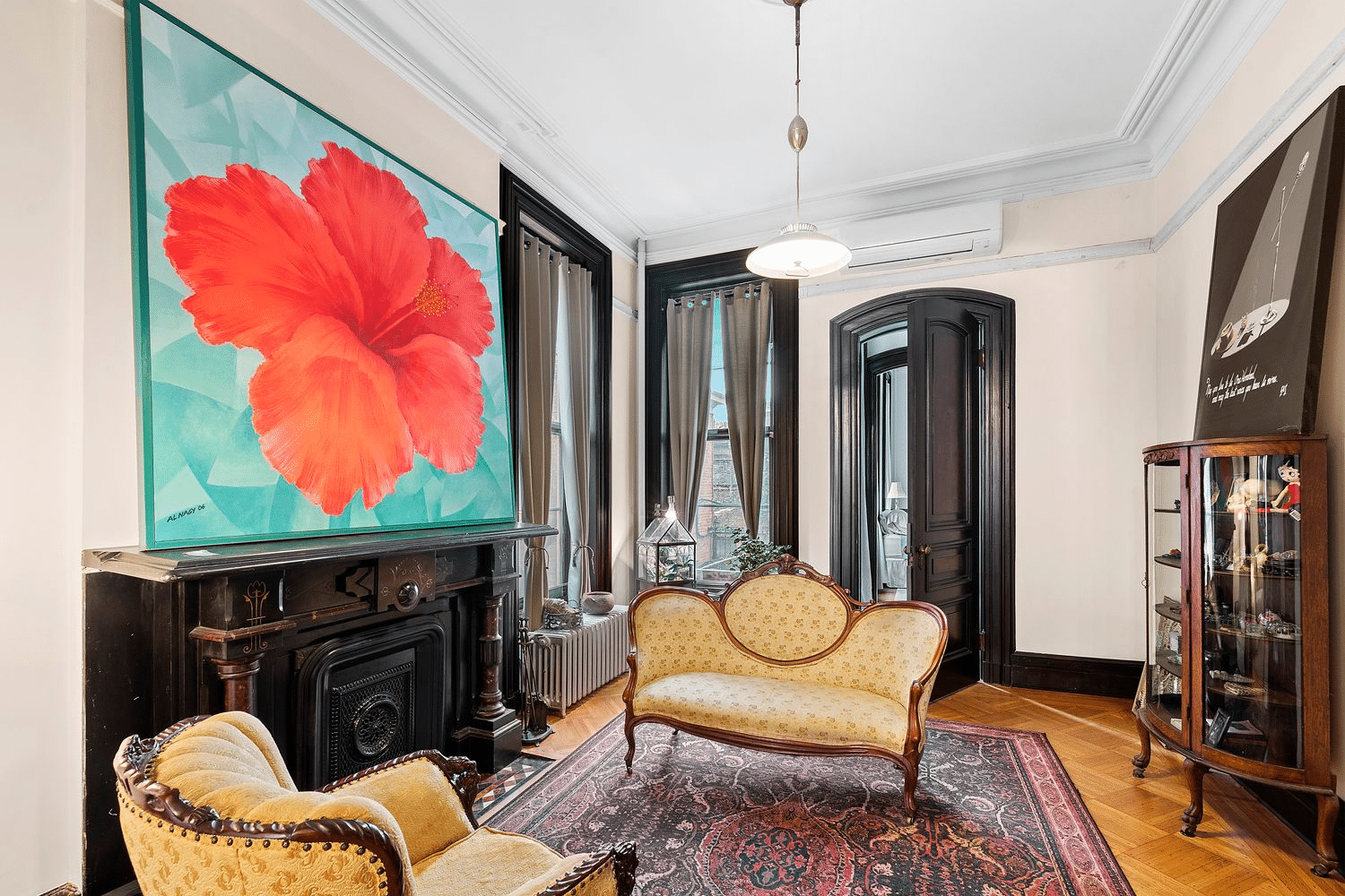 parlor with mantel, wood floor, mini split