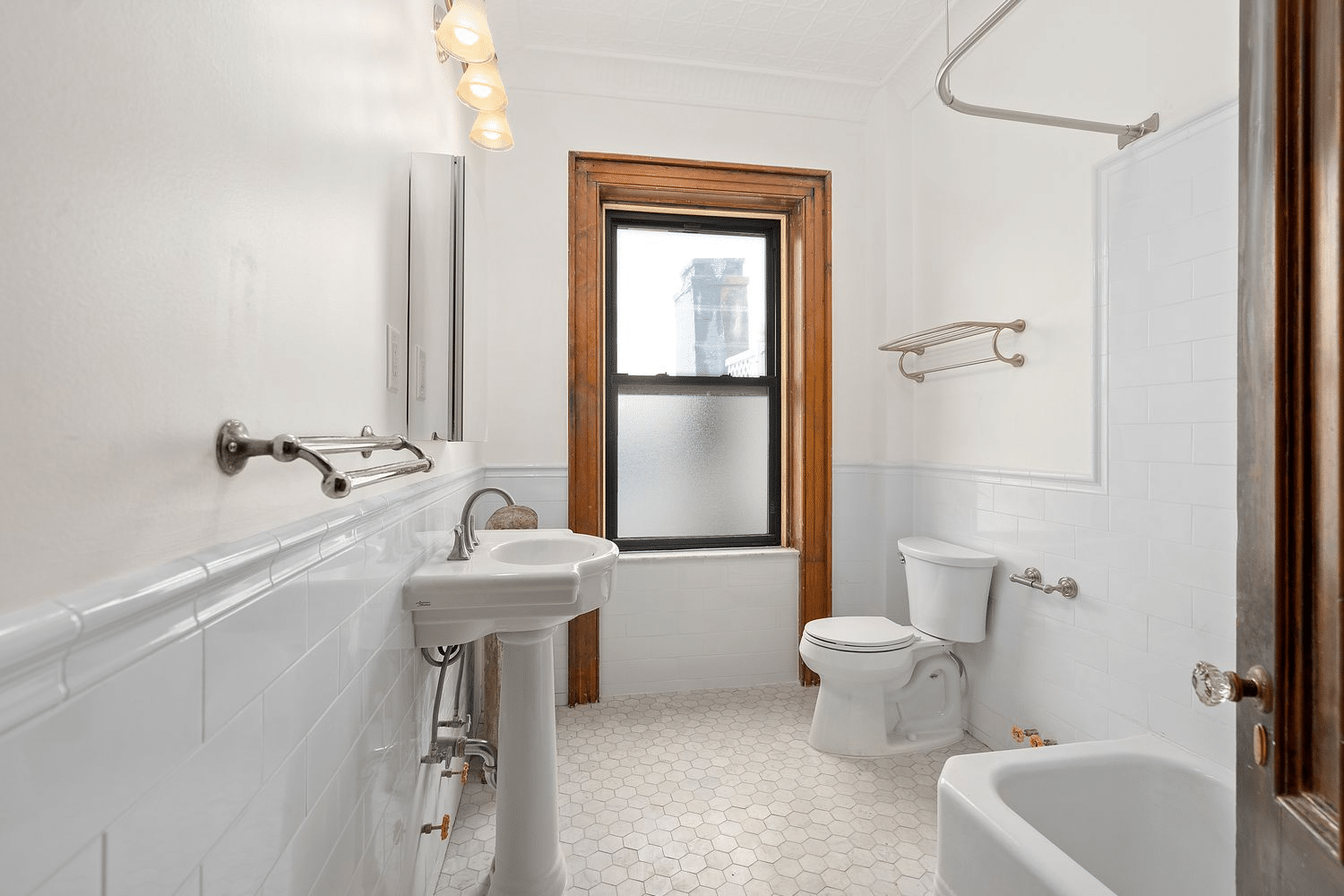 bathroom with white fixtures and tile