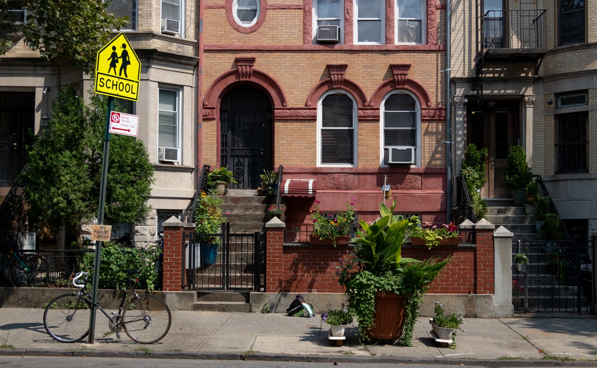 brooklyn - a sidewalk in crown heights with planters and a bike