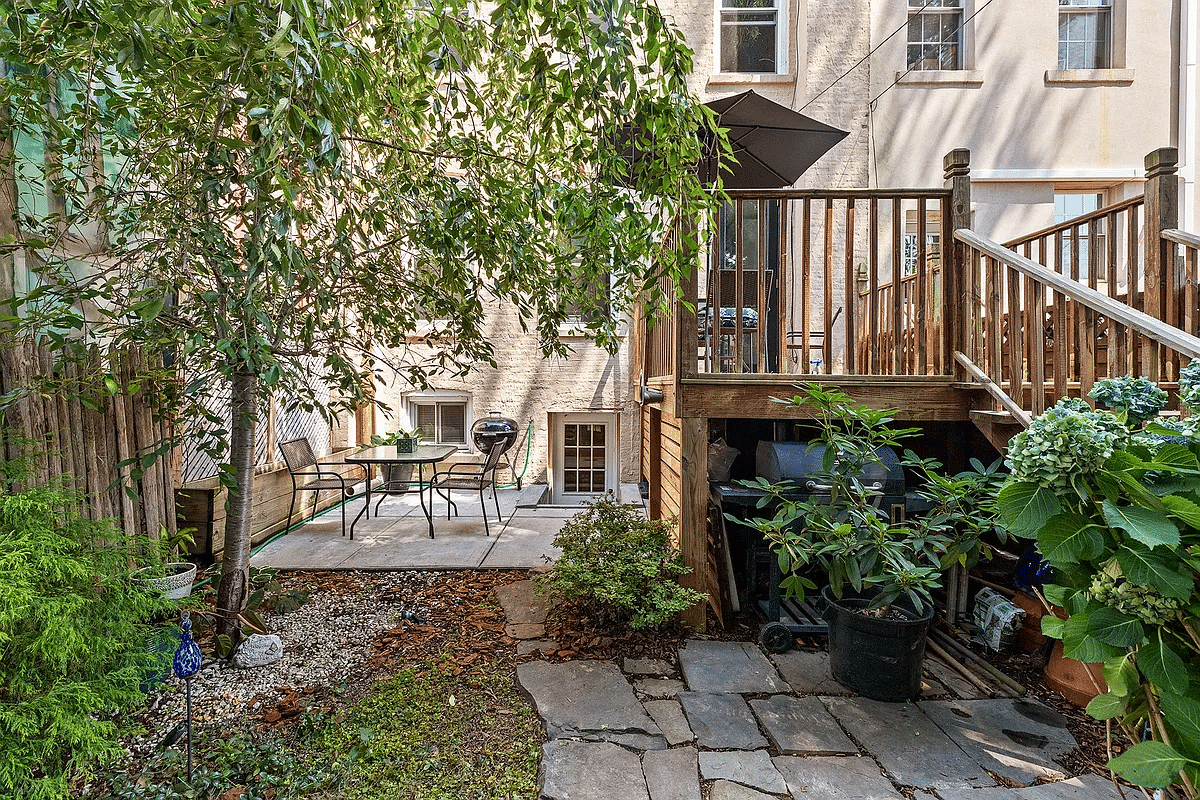 view of rear yard with a deck, paved patio and lawn